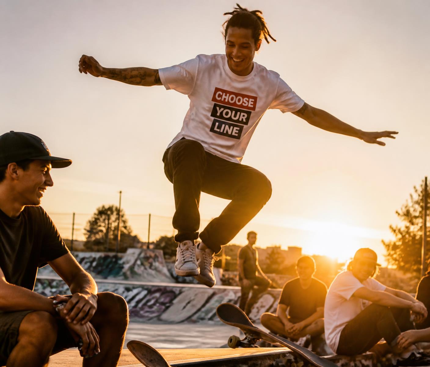 Friends at a graffiti skatepark cheering a skater in a GoForIt tee
